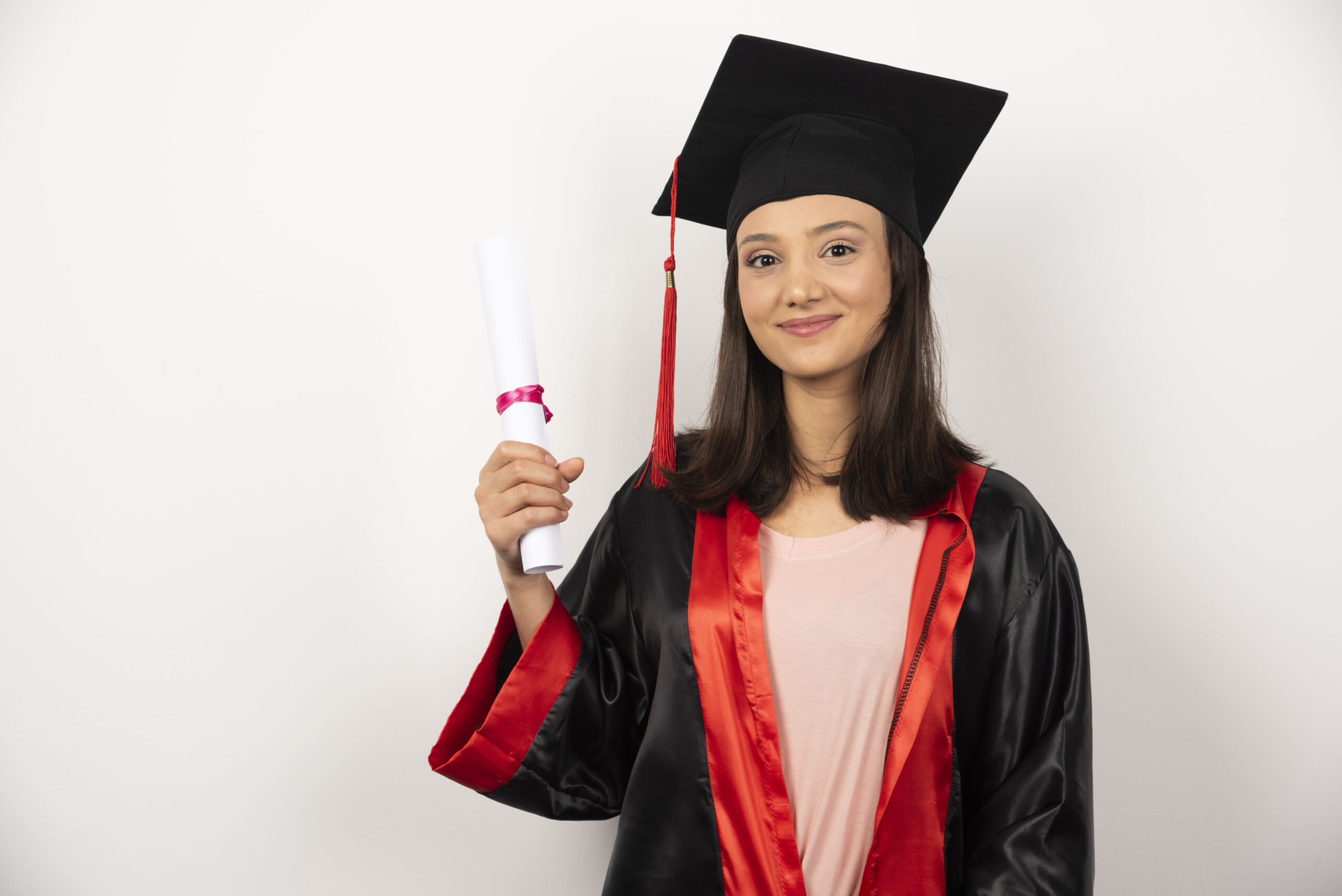 fresh graduate with diploma posing on white background